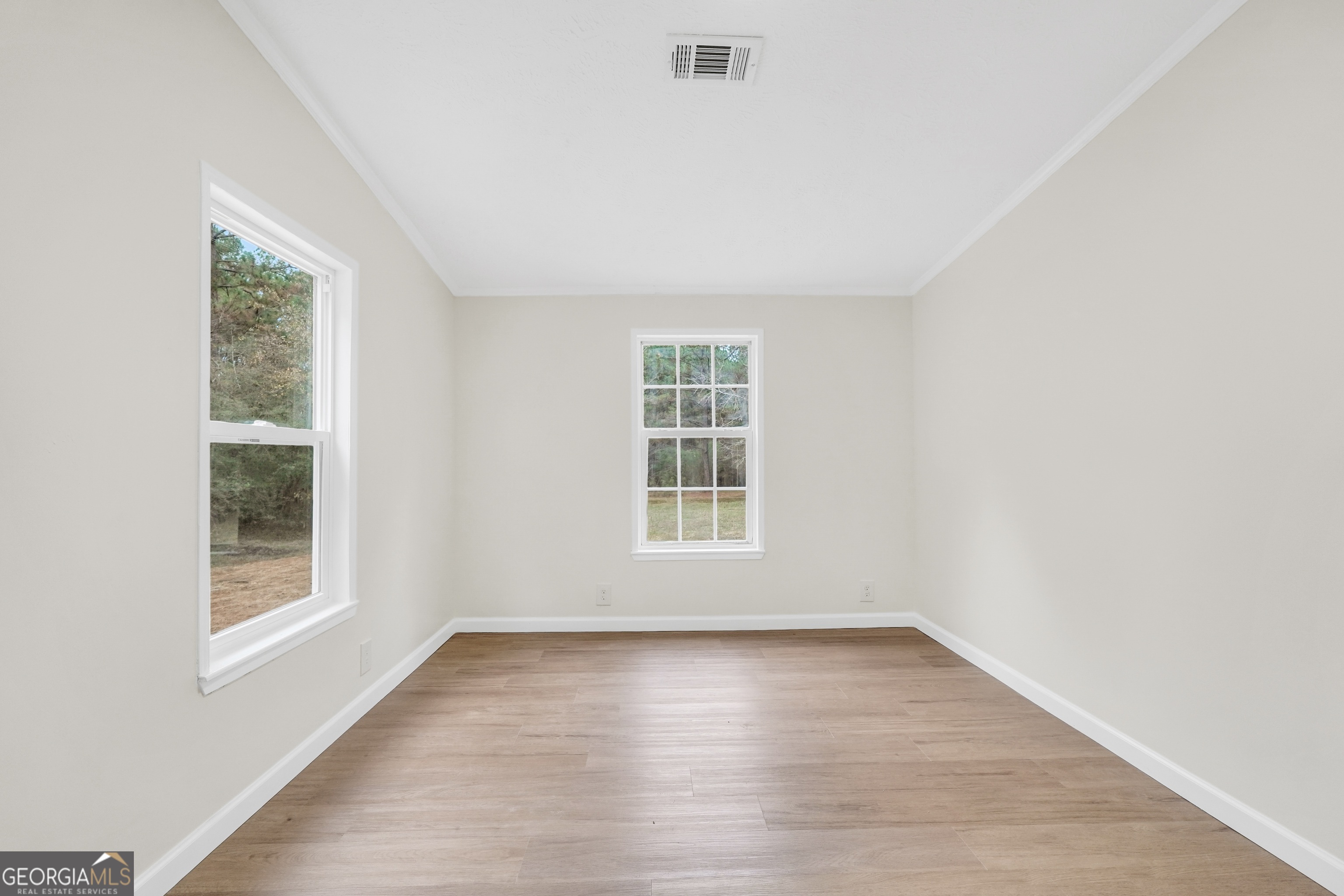 196 Craig Road Forsyth, GA 31029 - Photo 24 of 39 an empty room with wooden floor and windows