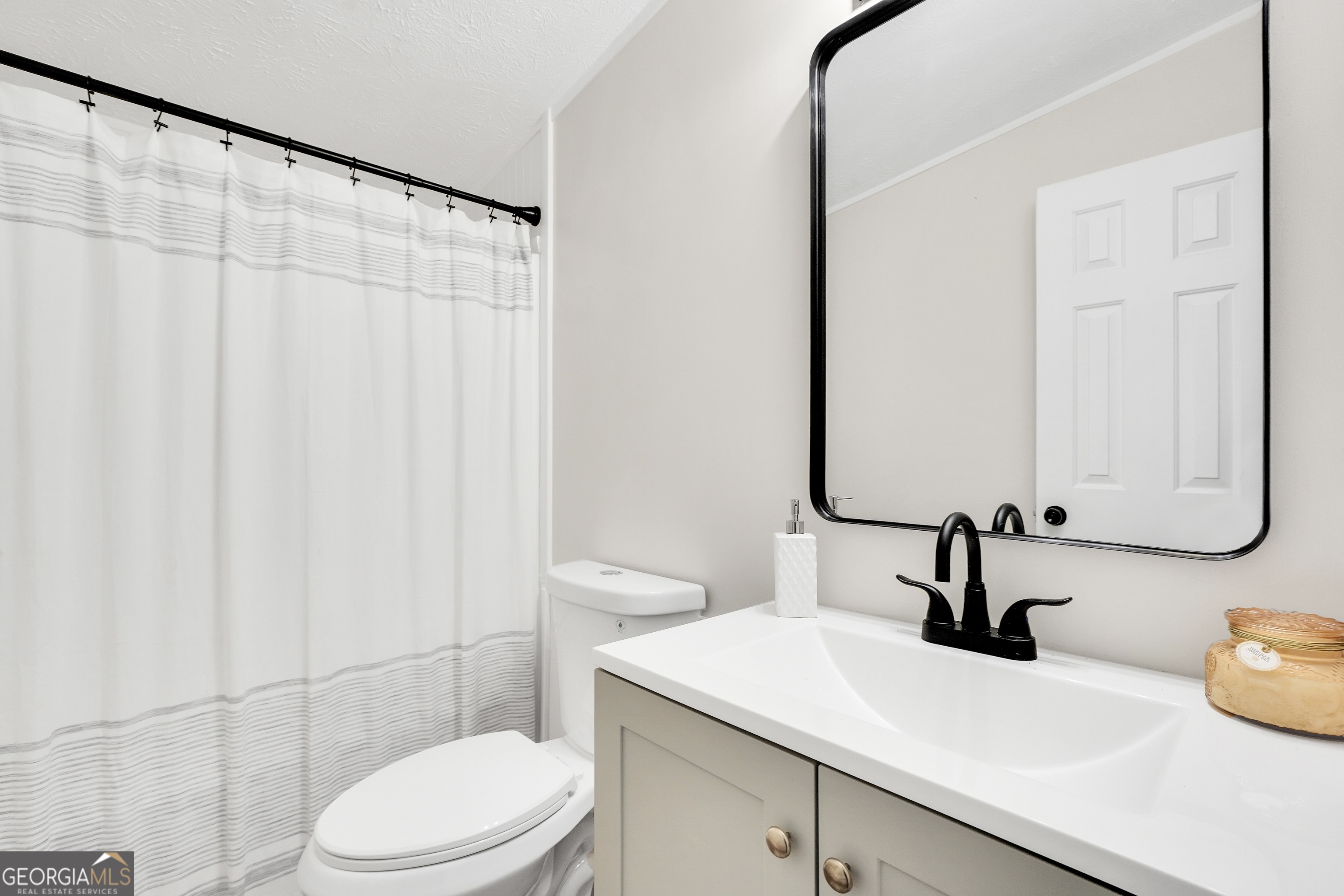 196 Craig Road Forsyth, GA 31029 - Photo 26 of 39 a bathroom with a sink and a mirror