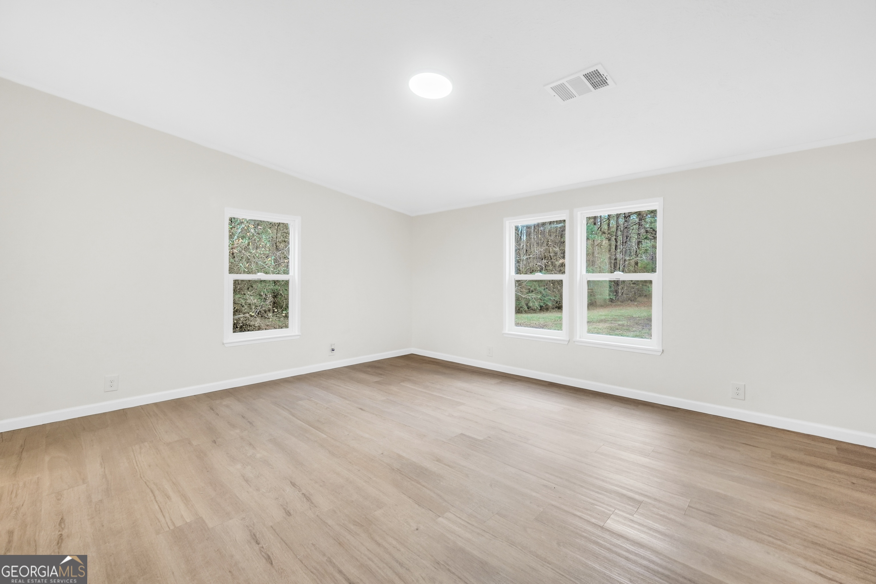 196 Craig Road Forsyth, GA 31029 - Photo 27 of 39 an empty room with wooden floor and windows