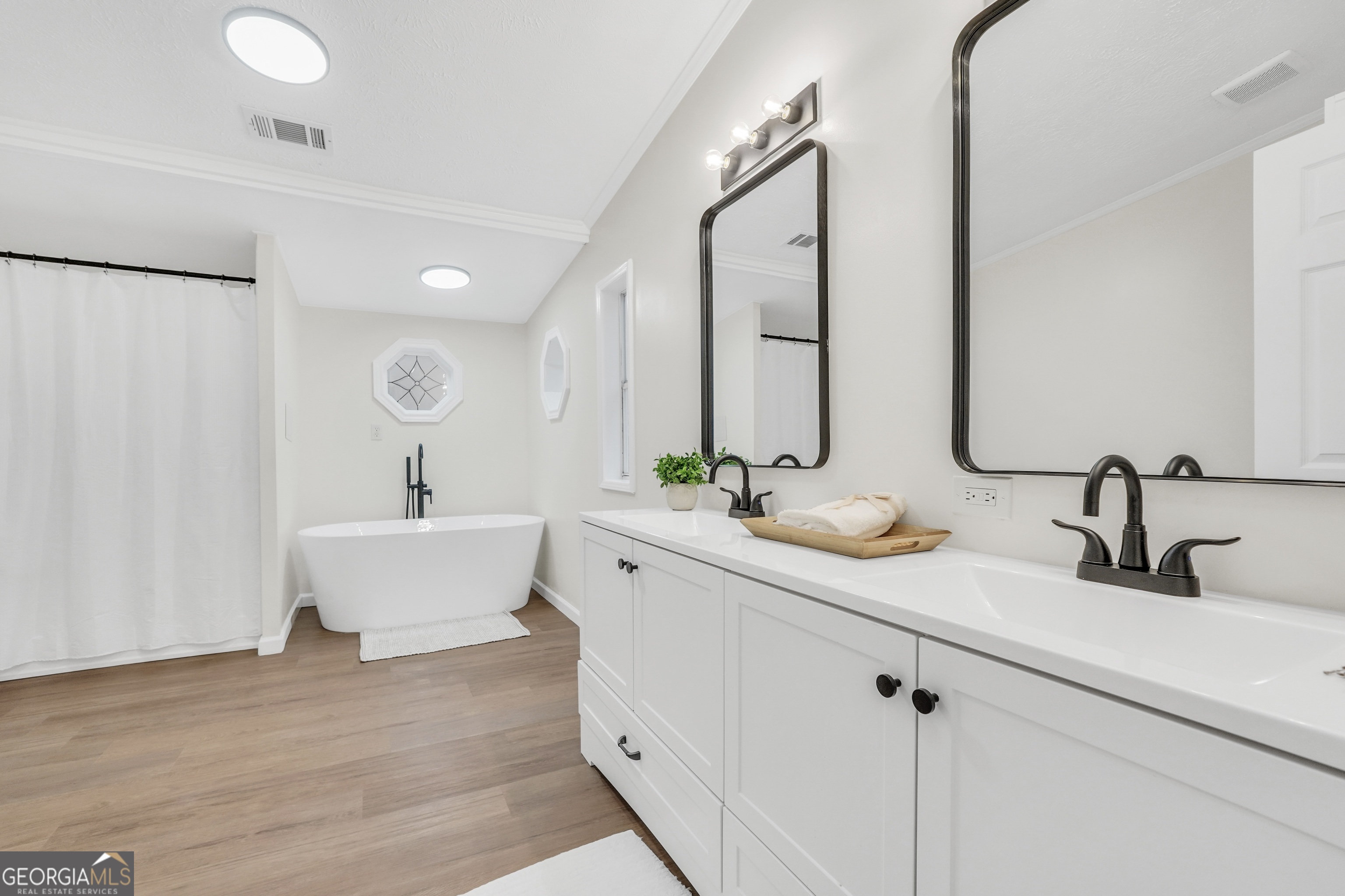 196 Craig Road Forsyth, GA 31029 - Photo 30 of 39 a bathroom with double vanity sinks a mirror and shower