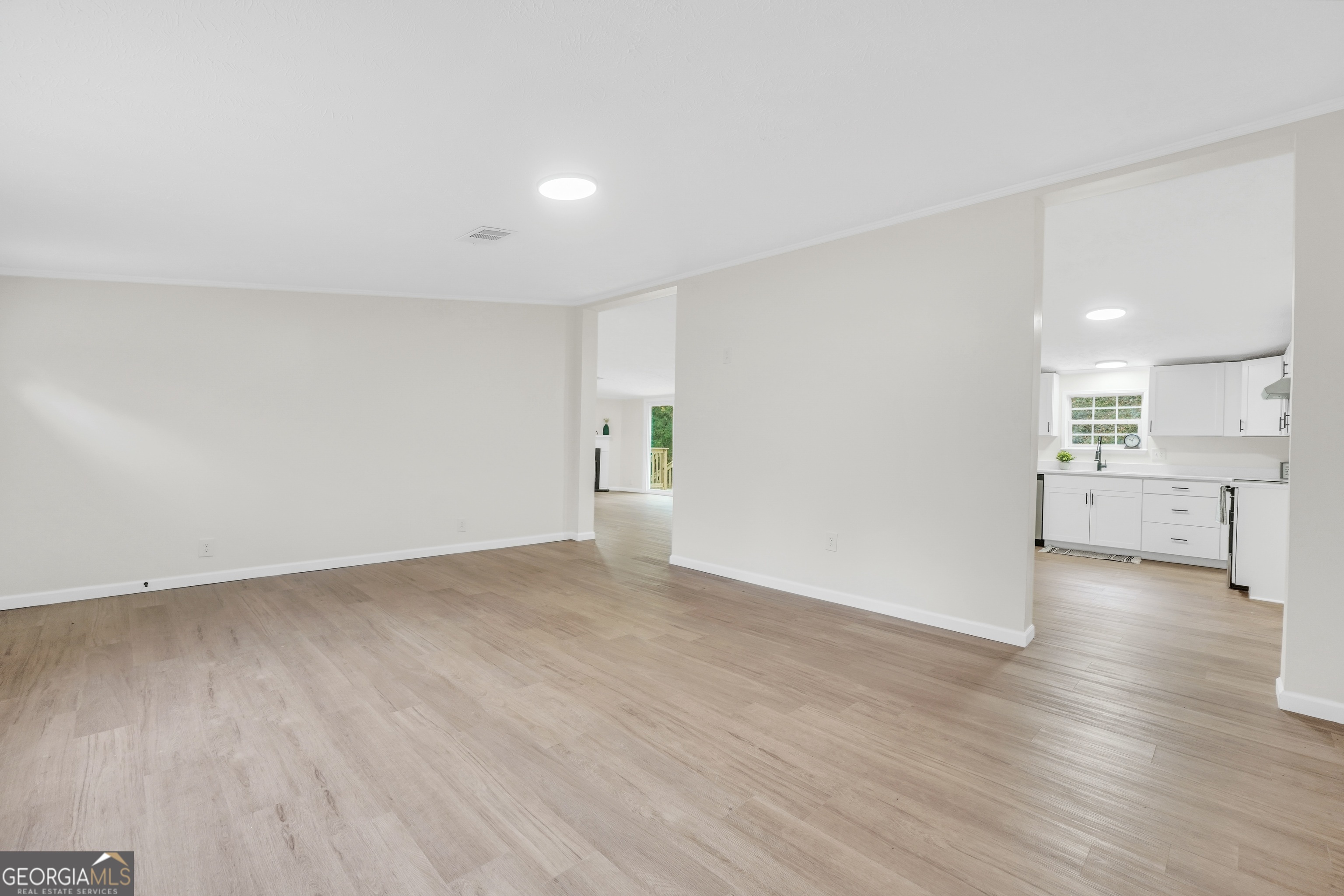 196 Craig Road Forsyth, GA 31029 - Photo 8 of 39 a view of a big room with wooden floor and windows