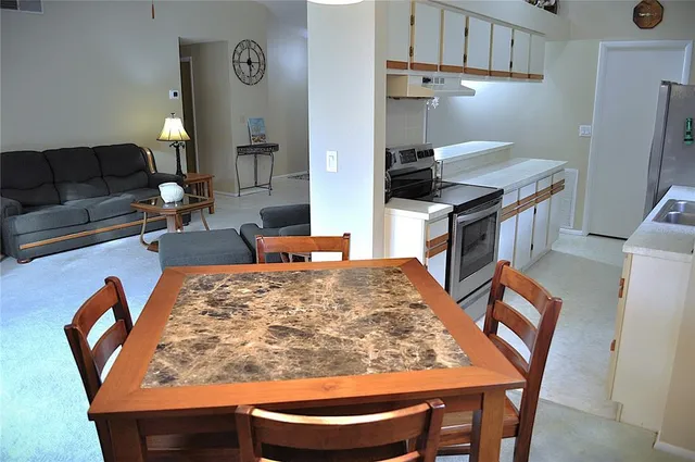 a living room with furniture and a rug