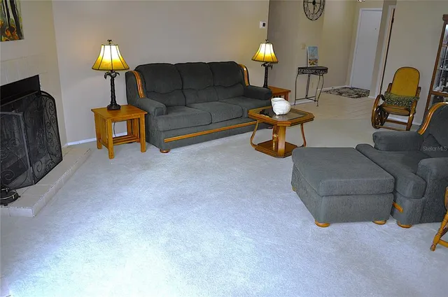 a living room with furniture and a lamp