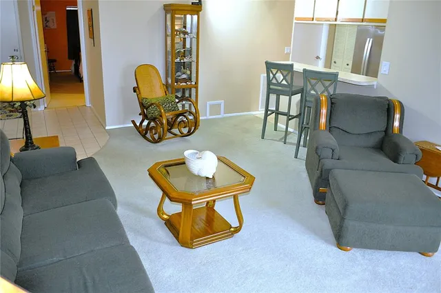 a living room with furniture and a lamp