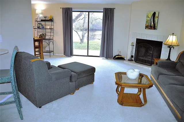 a living room with furniture a window and a fireplace