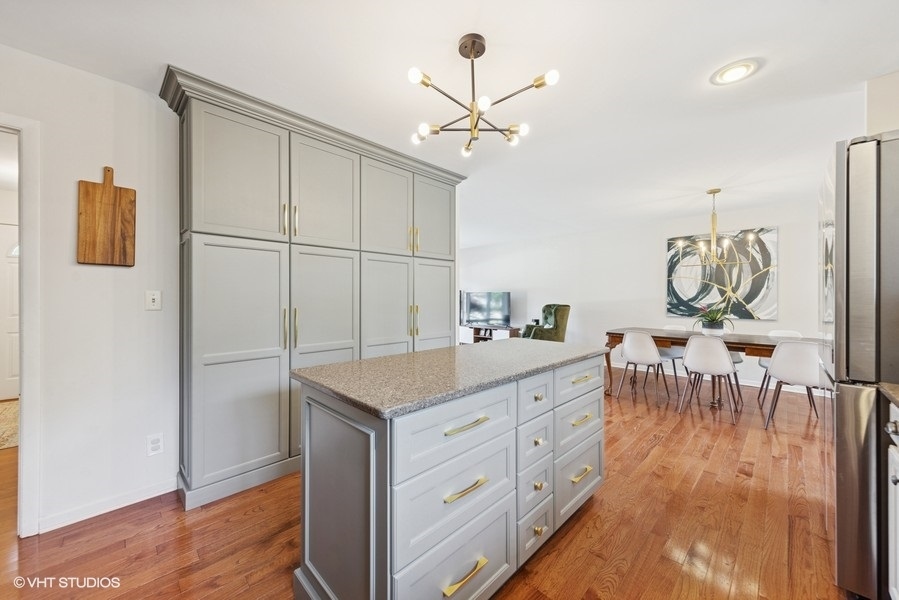 527 Maple Lane Geneva, IL 60134 - Photo 23 of 42 a kitchen with sink cabinets and wooden floor