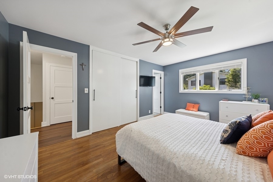 527 Maple Lane Geneva, IL 60134 - Photo 26 of 42 a bedroom with a large bed and a chandelier