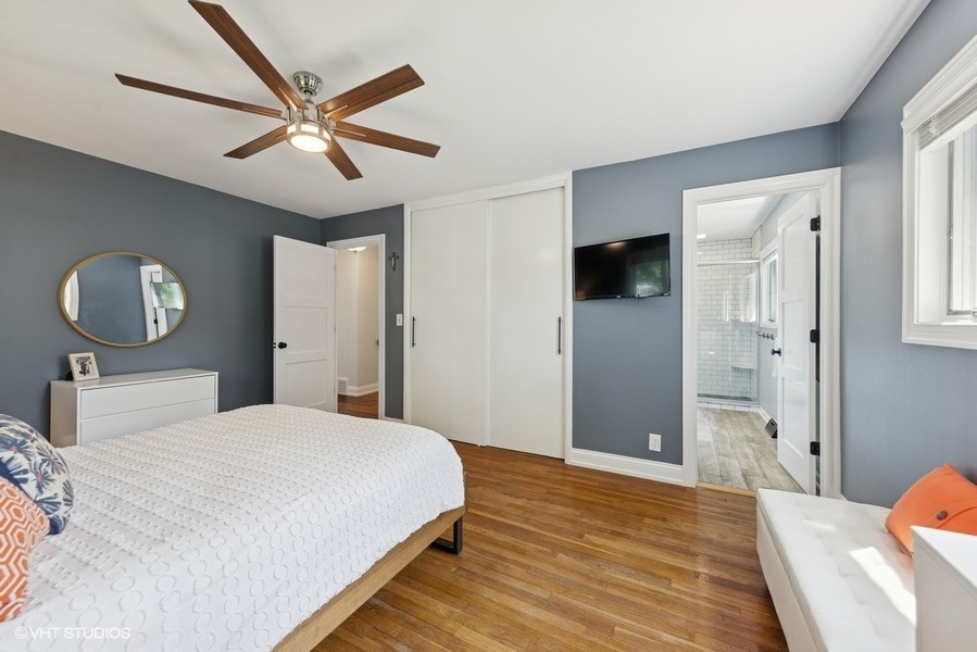 527 Maple Lane Geneva, IL 60134 - Photo 27 of 42 a bedroom with a large bed and a chandelier