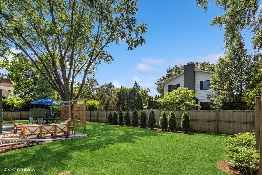 527 Maple Lane Geneva, IL 60134 - Photo 5 of 42 a view of a backyard with couches with wooden fence and plants
