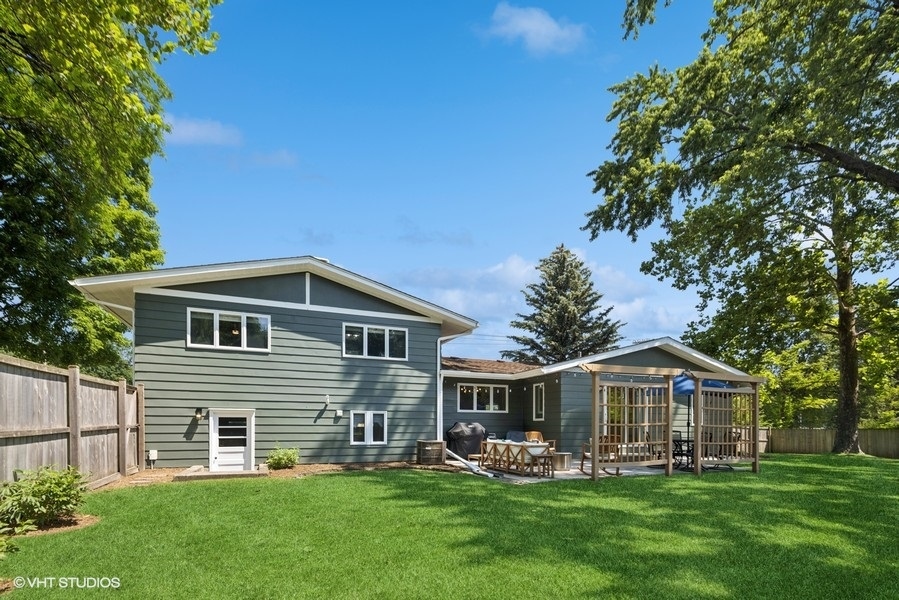 527 Maple Lane Geneva, IL 60134 - Photo 6 of 42 a front view of a house with a garden and trees