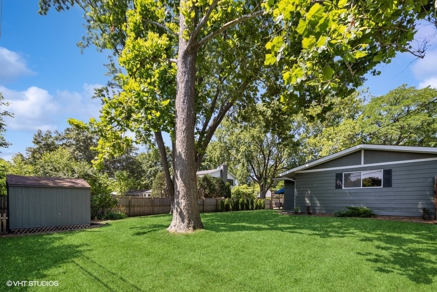 527 Maple Lane Geneva, IL 60134 - Photo 9 of 42 a backyard of a house with plants and large tree