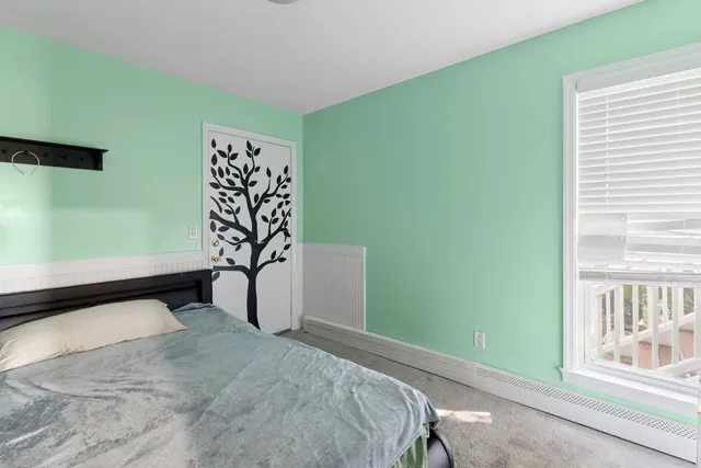 a bedroom with two beds and a closet