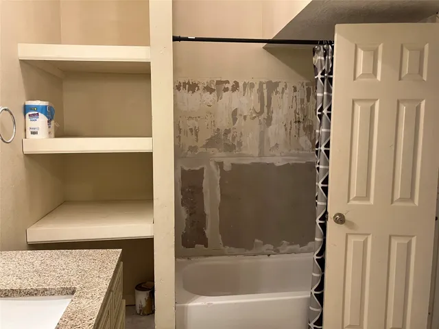 a bathroom with a bathtub and a shower