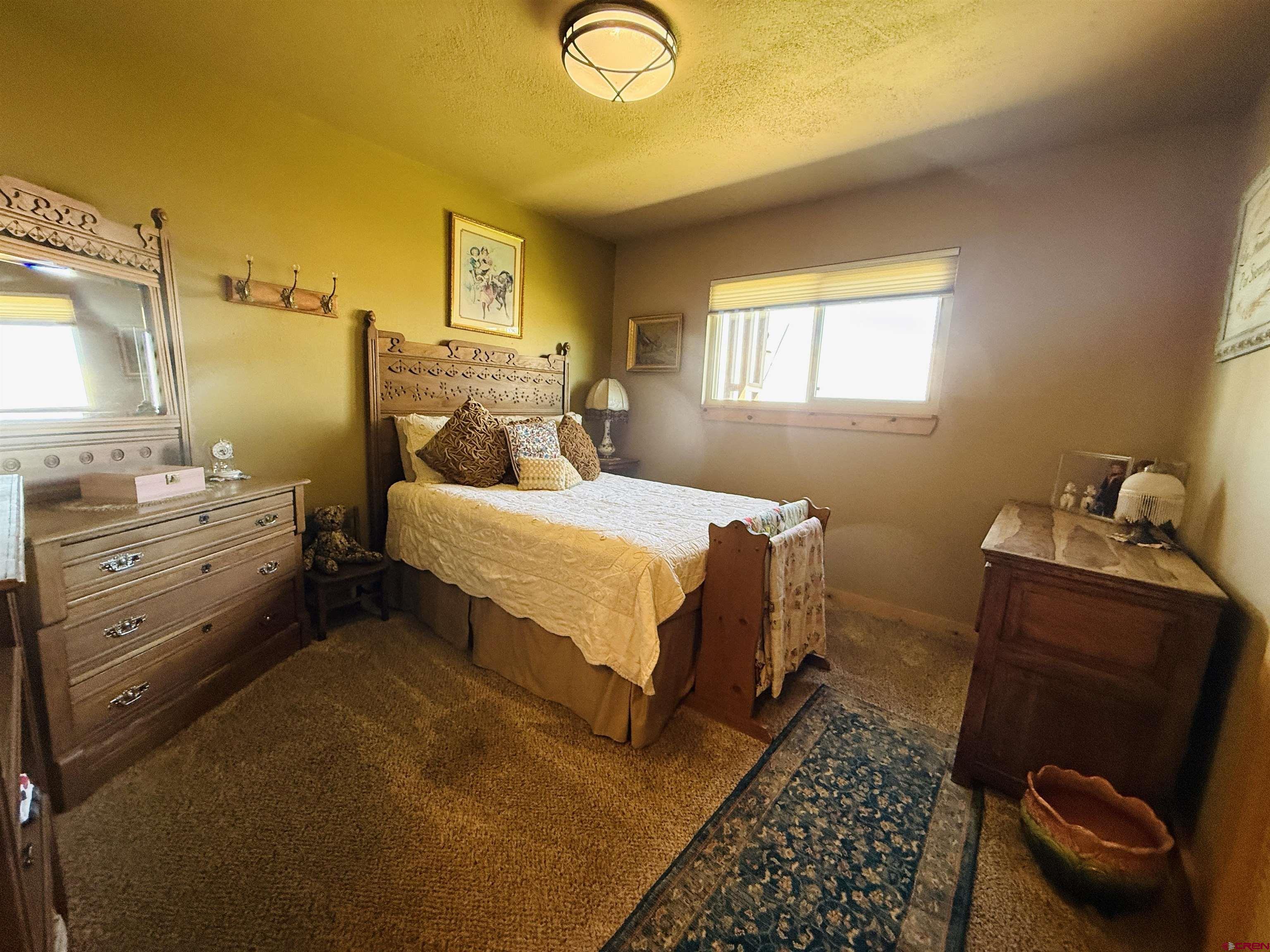 22680 E Road Delta, CO 81416 - Photo 11 of 31 a bedroom with a bed and wooden floor