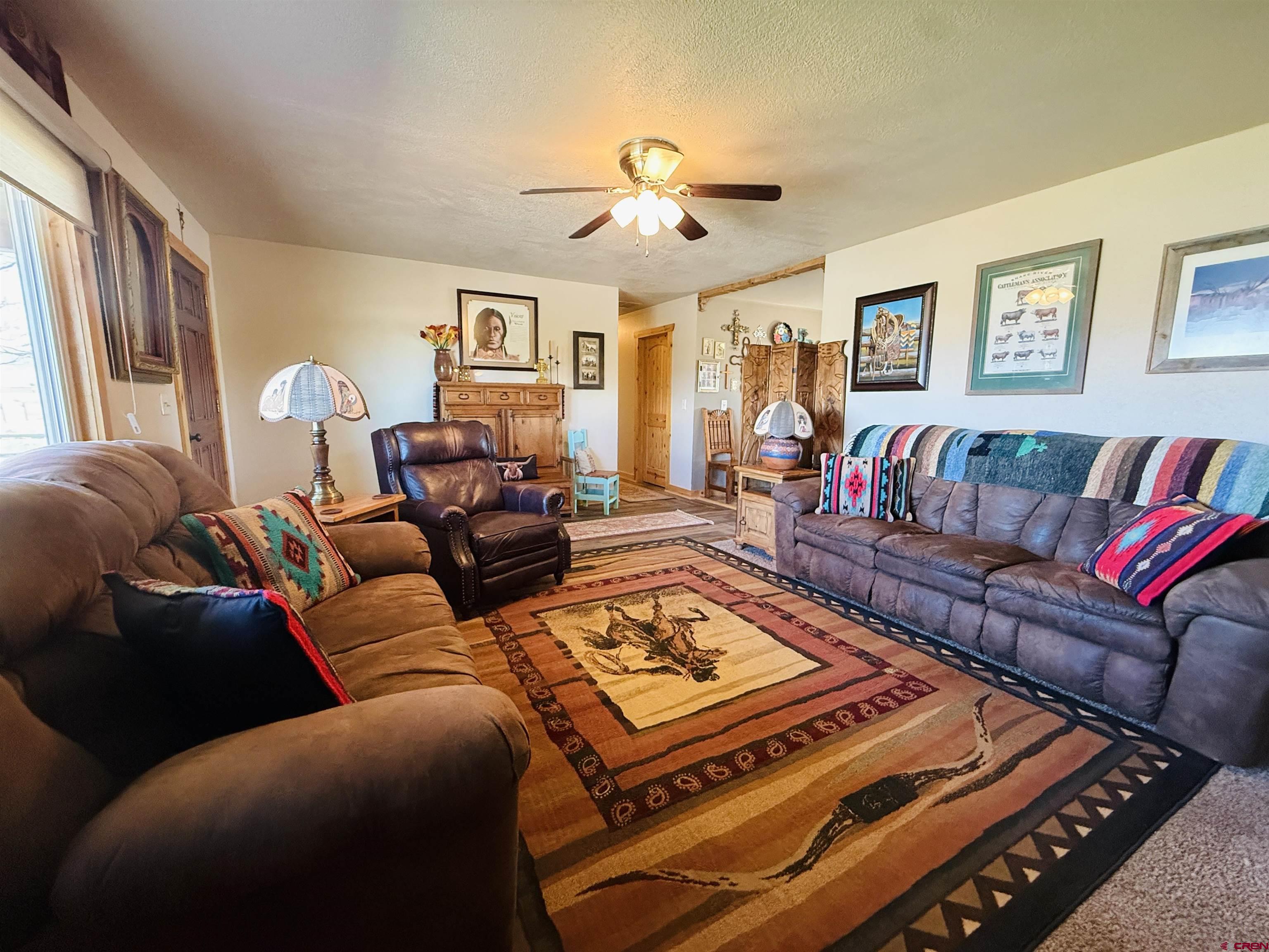 22680 E Road Delta, CO 81416 - Photo 13 of 31 a living room with furniture and a rug