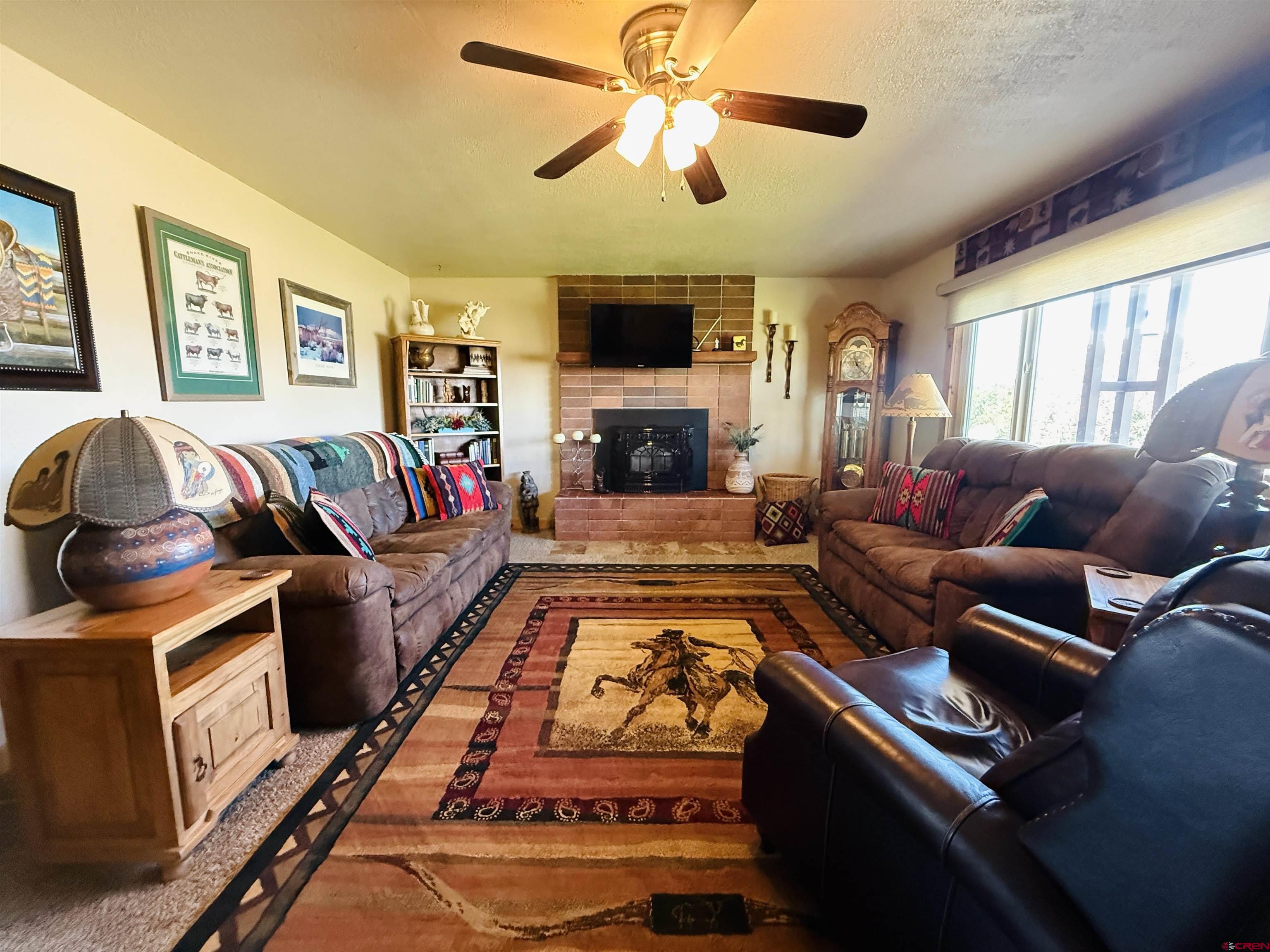 22680 E Road Delta, CO 81416 - Photo 15 of 31 a living room with furniture fireplace and flat screen tv