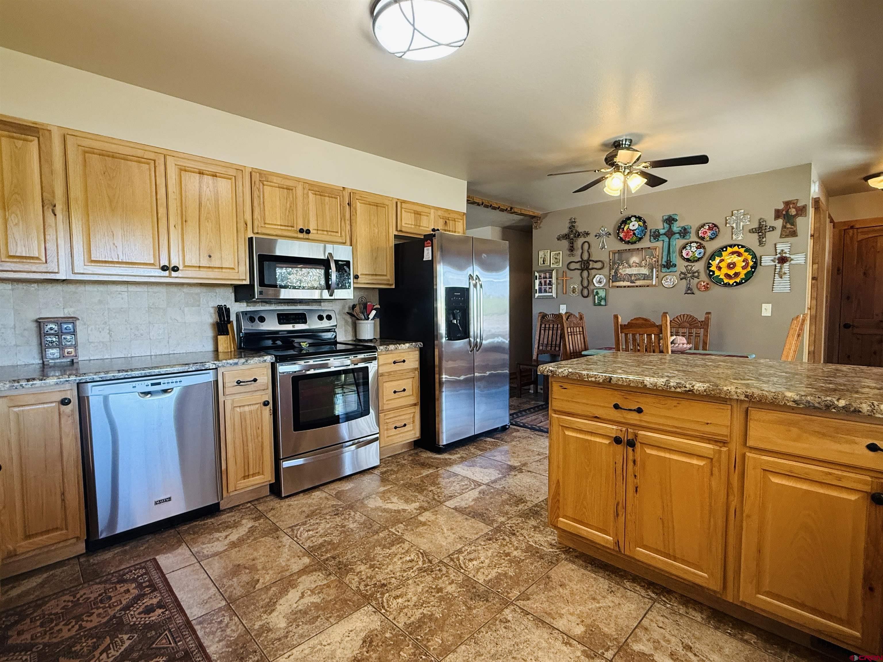 22680 E Road Delta, CO 81416 - Photo 18 of 31 a kitchen with stainless steel appliances granite countertop a stove and a sink