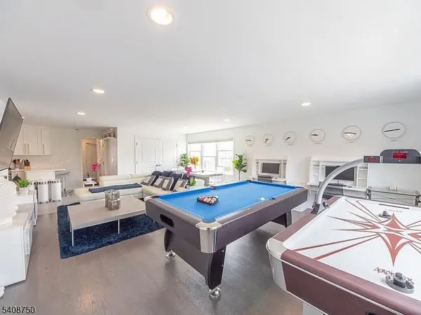 a living room with furniture pool and table
