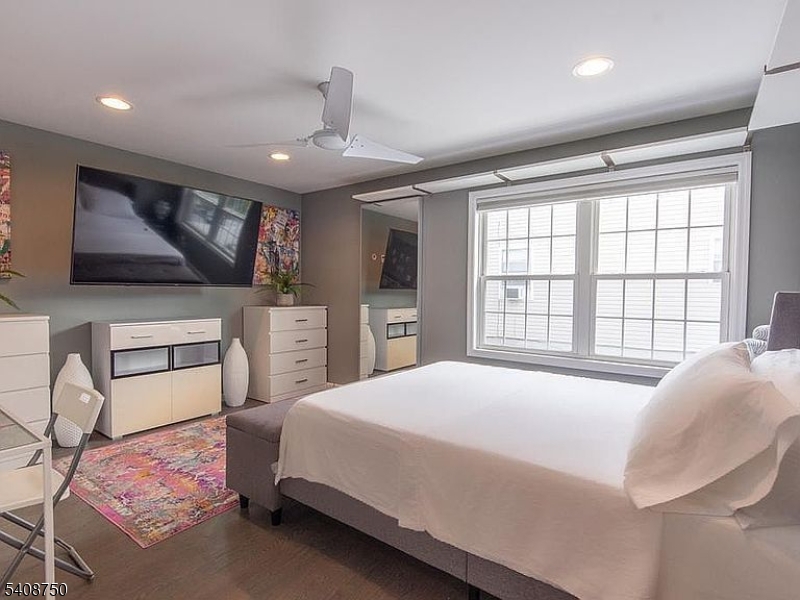 201 Catherine Street, Unit 1 Elizabeth, NJ 07201 - Photo 13 of 25 a spacious bedroom with a bed and a flat screen tv
