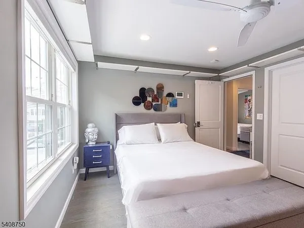 a bedroom with a large bed and a large window