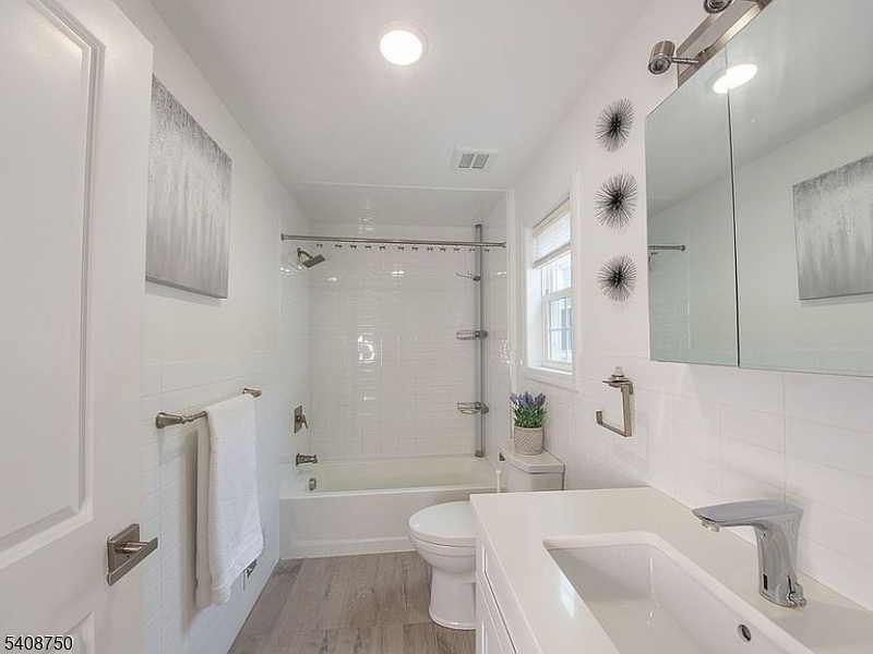 201 Catherine Street, Unit 1 Elizabeth, NJ 07201 - Photo 16 of 25 a bathroom with a bathtub shower sink mirror and toilet