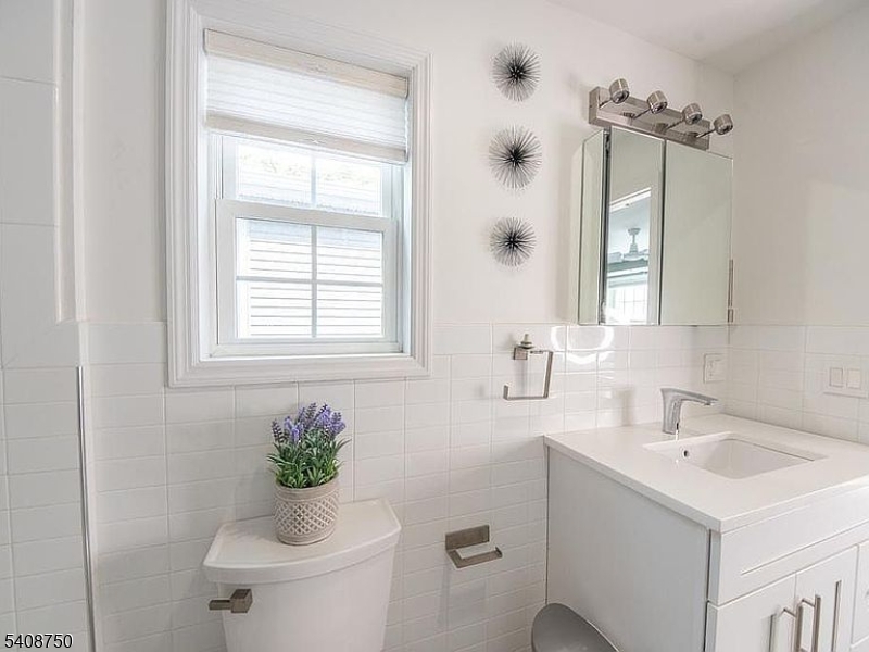 201 Catherine Street, Unit 1 Elizabeth, NJ 07201 - Photo 17 of 25 a bathroom with a sink a toilet and mirror