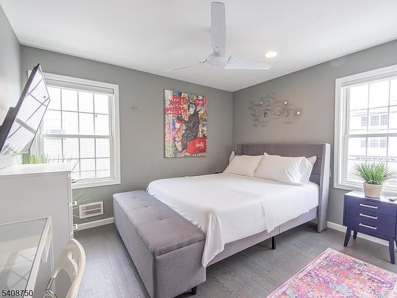 201 Catherine Street, Unit 1 Elizabeth, NJ 07201 - Photo 18 of 25 a bedroom with a bed wooden floor and window