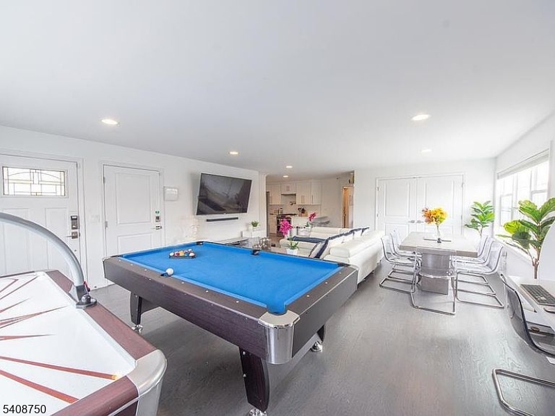 201 Catherine Street, Unit 1 Elizabeth, NJ 07201 - Photo 2 of 25 a living room with furniture a flat screen tv and a table
