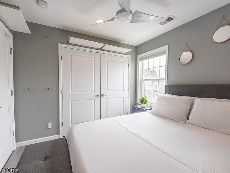 201 Catherine Street, Unit 1 Elizabeth, NJ 07201 - Photo 21 of 25 a bedroom with a large bed and chandelier