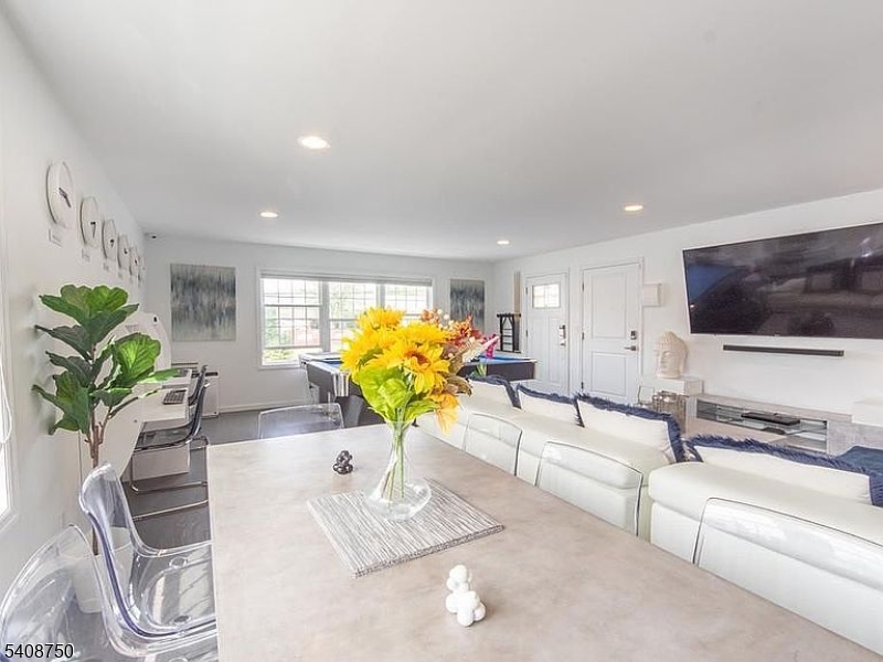 201 Catherine Street, Unit 1 Elizabeth, NJ 07201 - Photo 3 of 25 a living room with furniture flowerpot and a flat screen tv