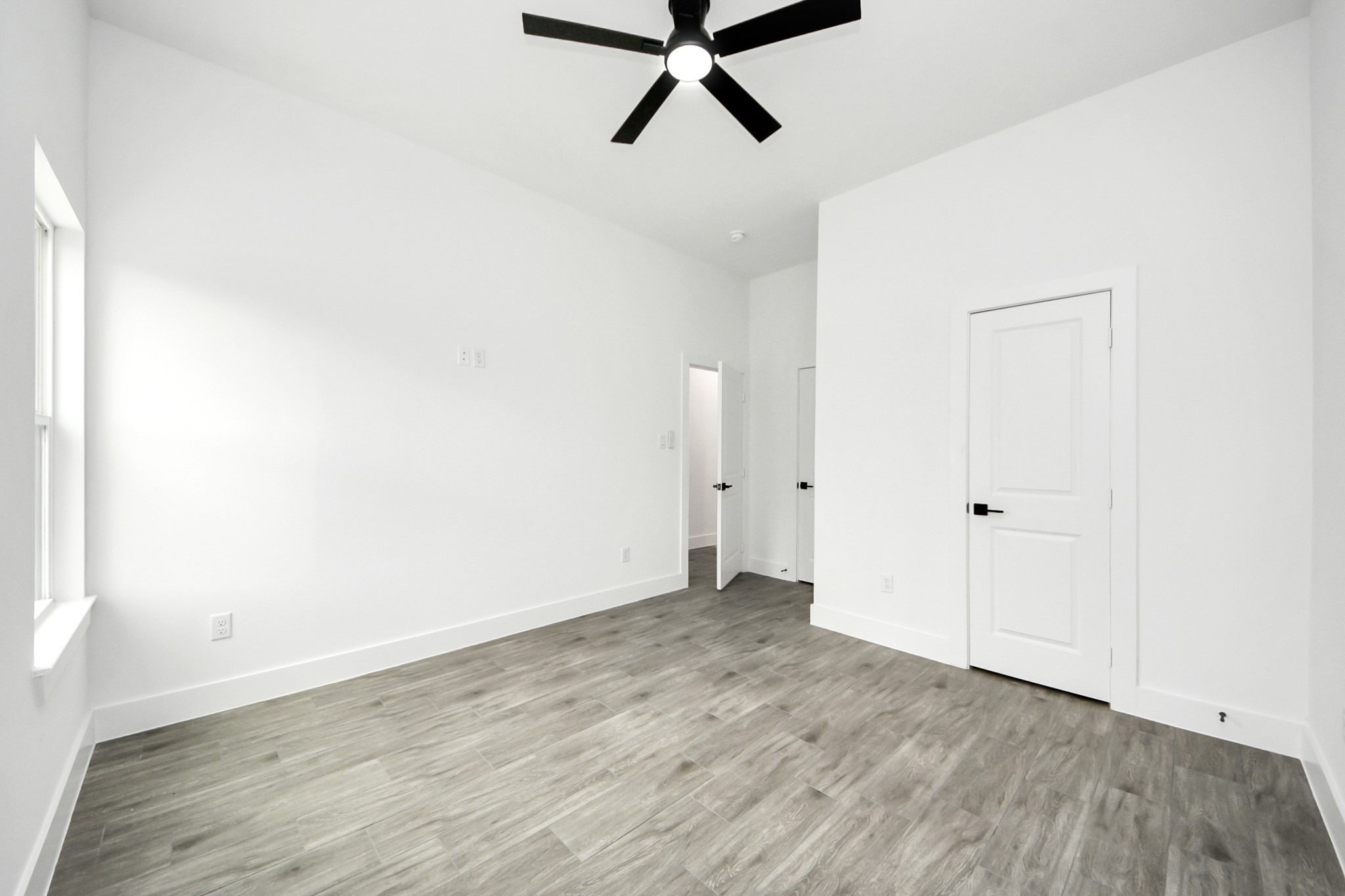 7412 Carver Road, Unit B Houston, TX 77088 - Photo 12 of 22 a view of a room with wooden floor and white walls