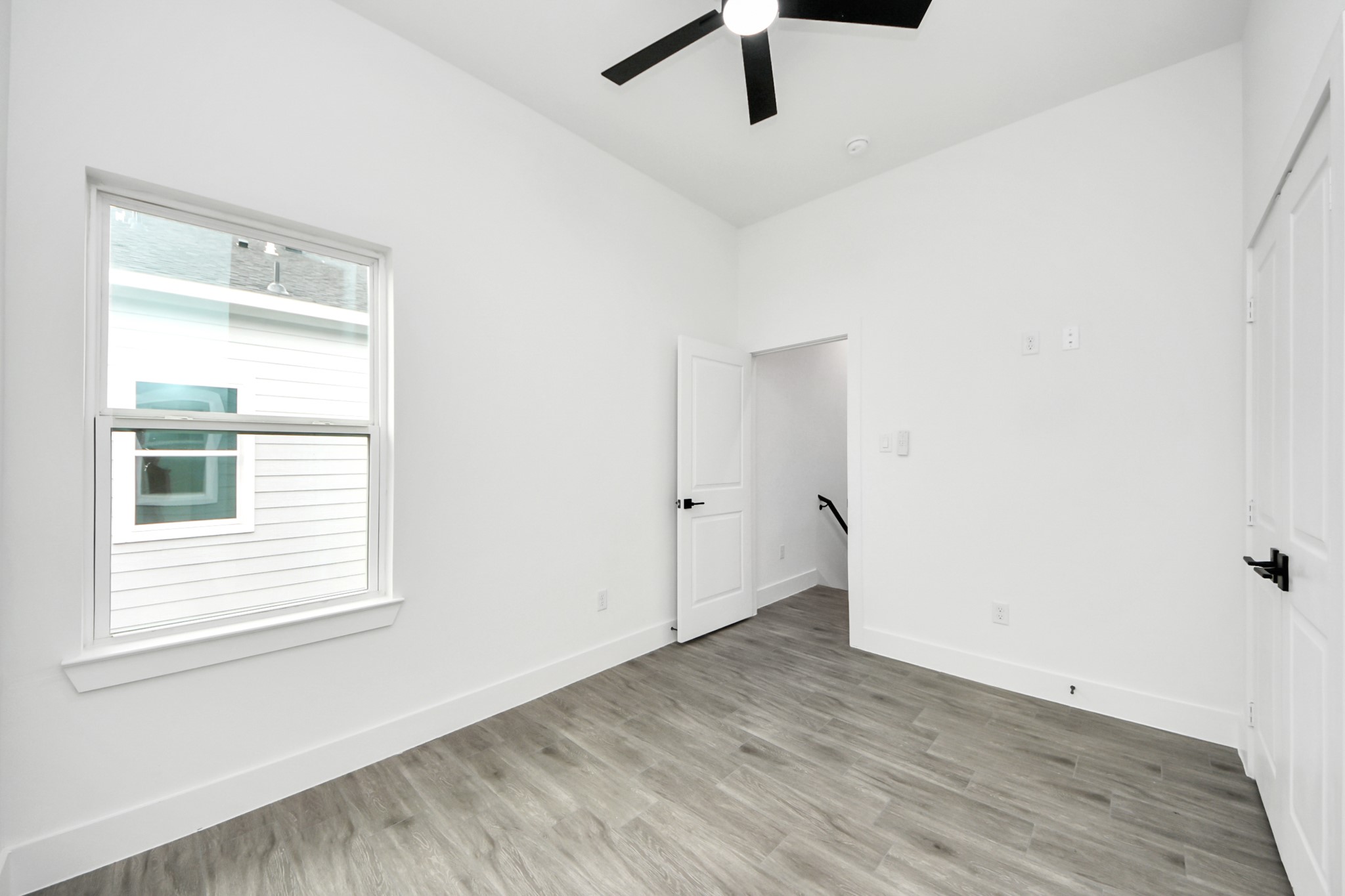 7412 Carver Road, Unit B Houston, TX 77088 - Photo 19 of 22 wooden floor in an empty room with a window