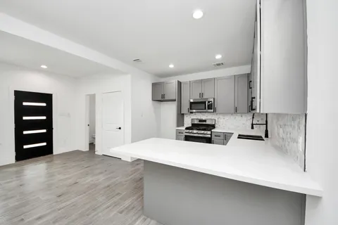 a kitchen with wooden cabinets and white appliances