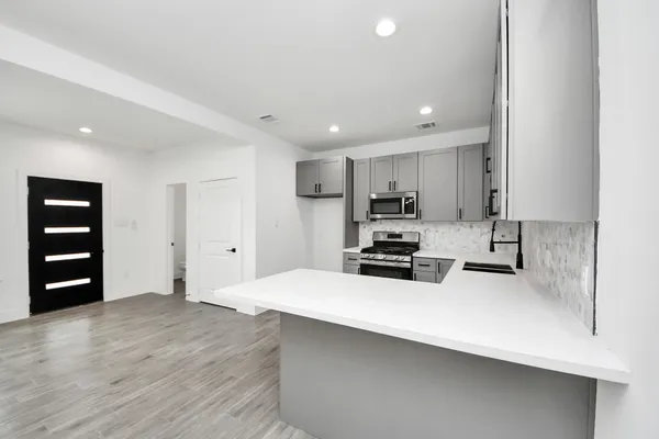 a kitchen with wooden cabinets and white appliances