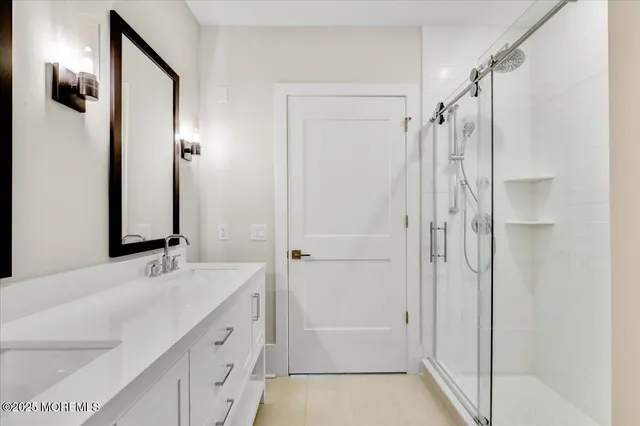 a bathroom with a double vanity sink and a mirror