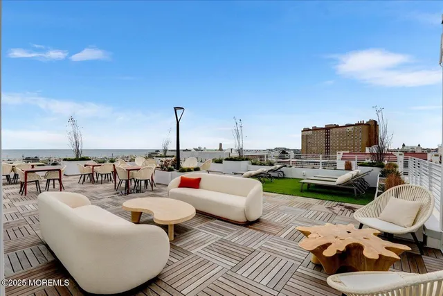 a view of a roof deck with furniture