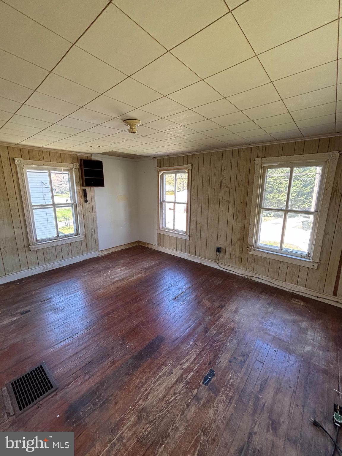 21447 East Sharp Street Rock Hall, MD 21661 - Photo 12 of 14 an empty room with wooden floor and windows