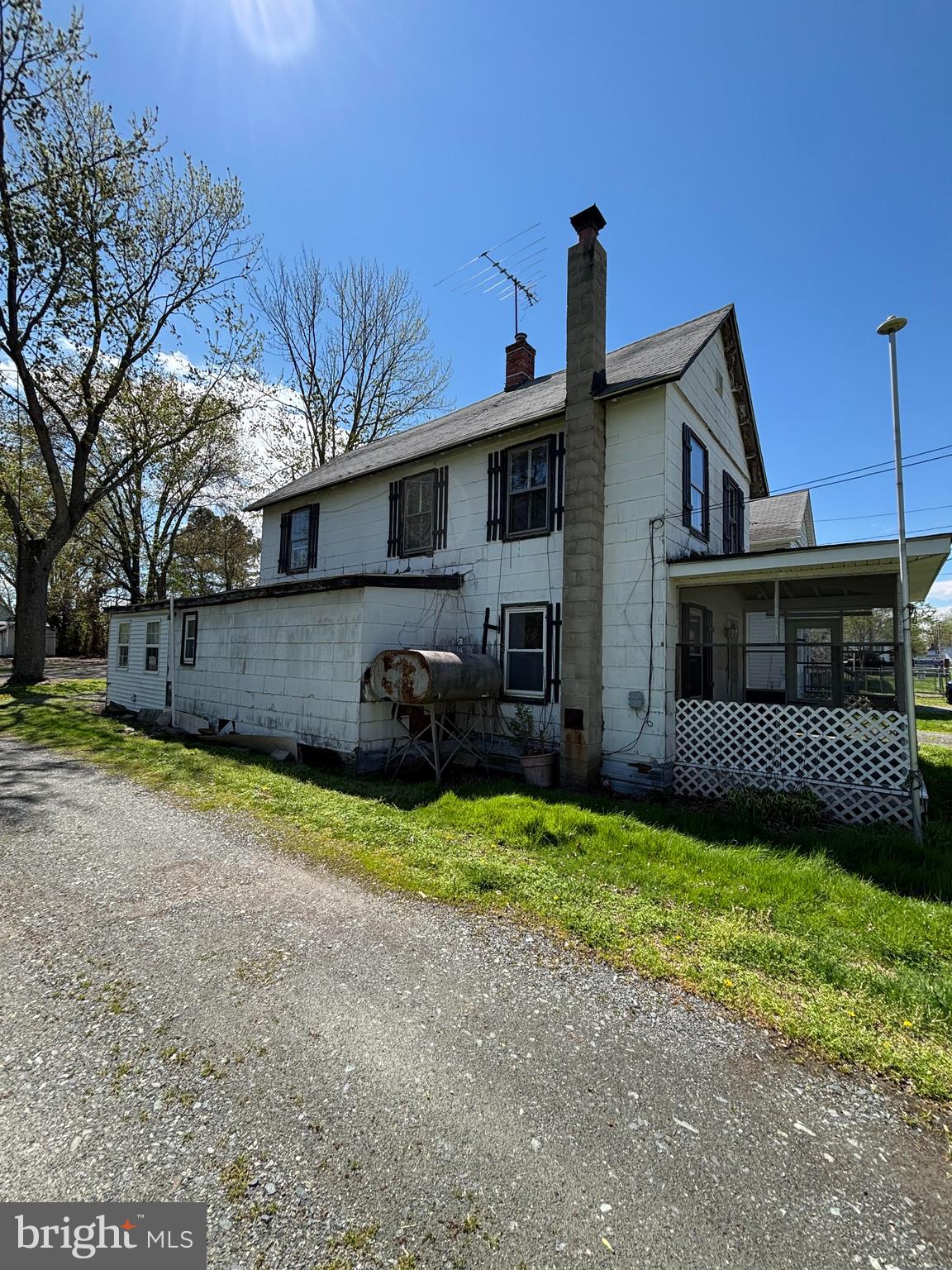 21447 East Sharp Street Rock Hall, MD 21661 - Photo 2 of 14 a front view of a house with a yard and garage