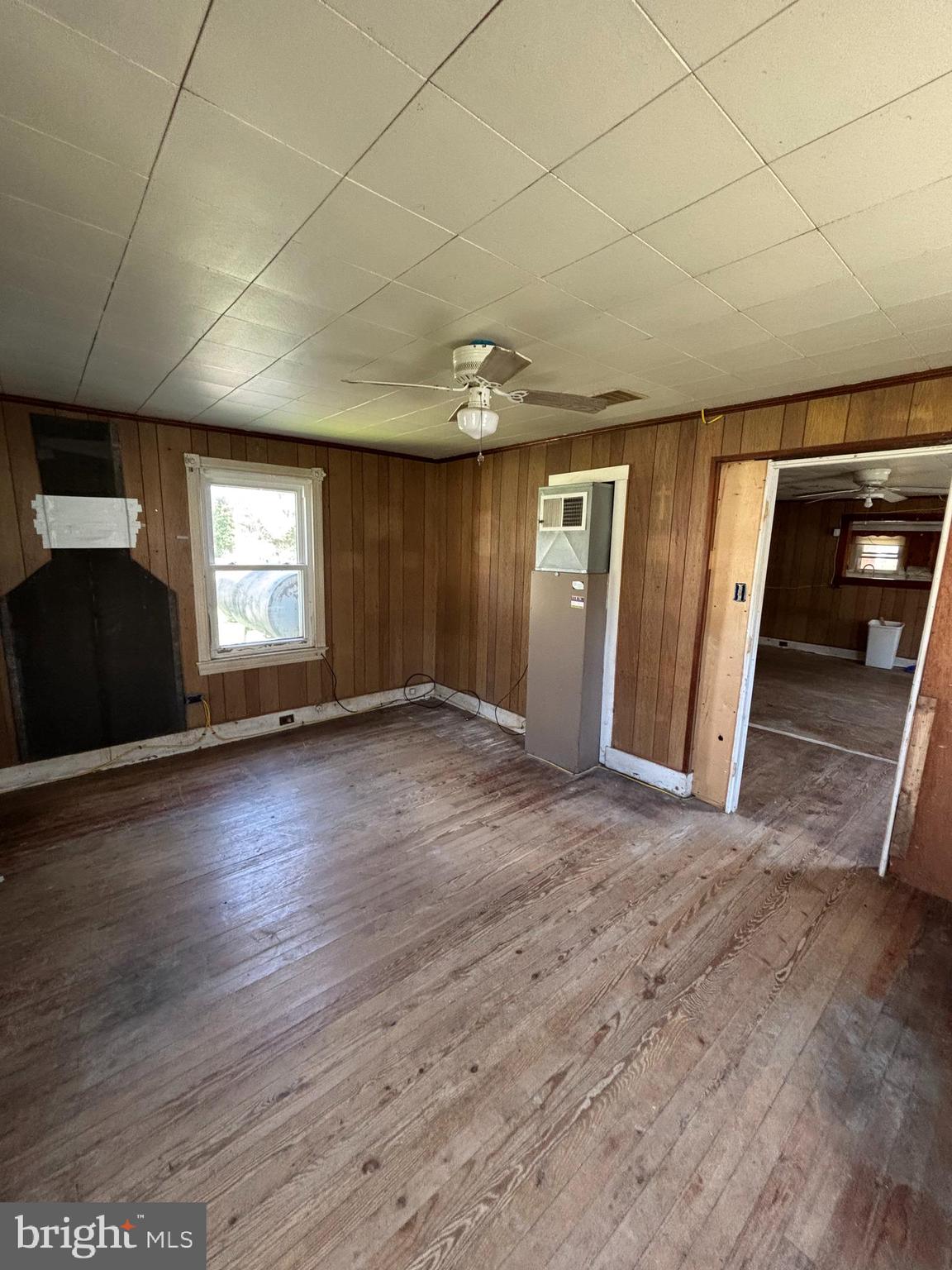 21447 East Sharp Street Rock Hall, MD 21661 - Photo 8 of 14 an empty room with wooden floor and window