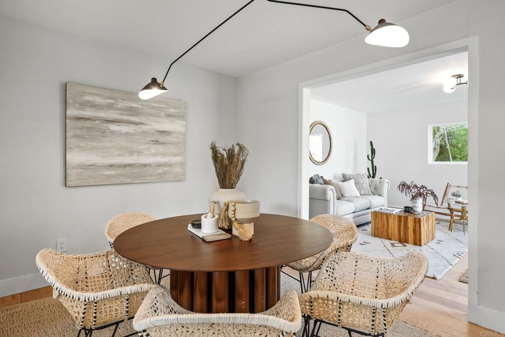 5898 Agee Street San Diego, CA 92122 - Photo 19 of 40 a view of a dining room with furniture a chandelier and wooden floor