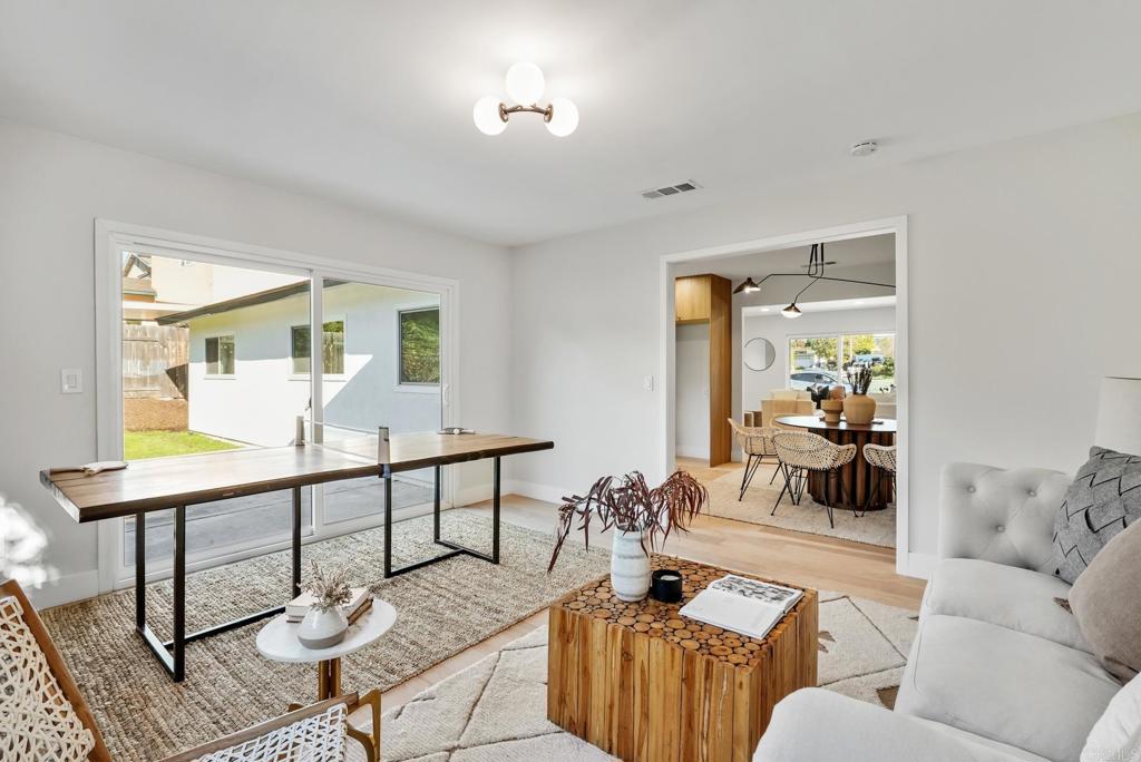 5898 Agee Street San Diego, CA 92122 - Photo 27 of 40 a living room with furniture and wooden floor