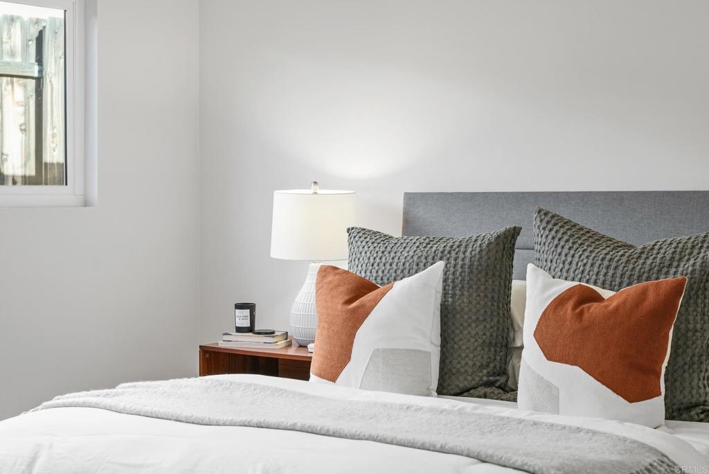 5898 Agee Street San Diego, CA 92122 - Photo 29 of 40 a bedroom with a bed and a couch