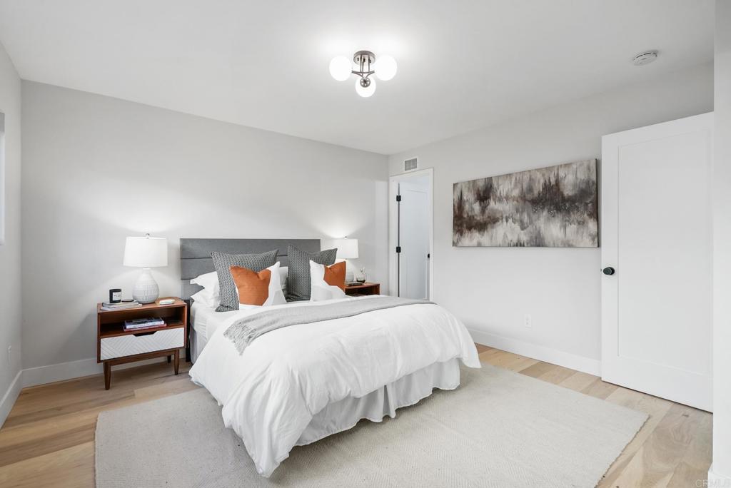 5898 Agee Street San Diego, CA 92122 - Photo 30 of 40 a bedroom with bed and a night stand