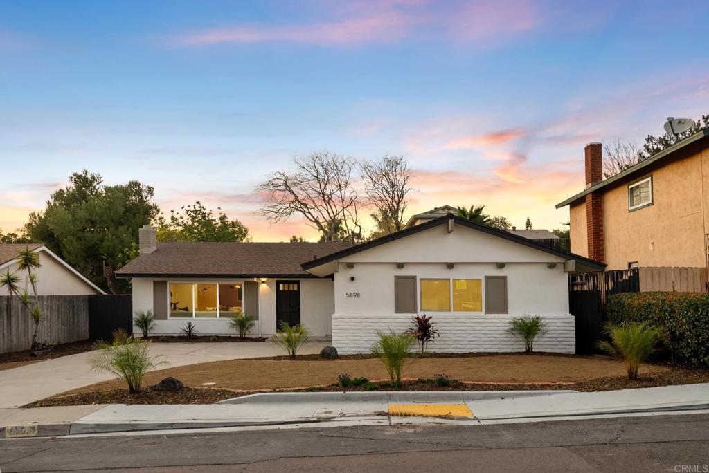 5898 Agee Street San Diego, CA 92122 - Photo 3 of 40 a front view of a house with a yard