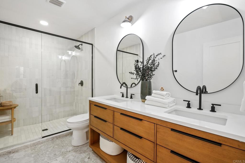 5898 Agee Street San Diego, CA 92122 - Photo 32 of 40 a bathroom with a double vanity sink toilet and shower