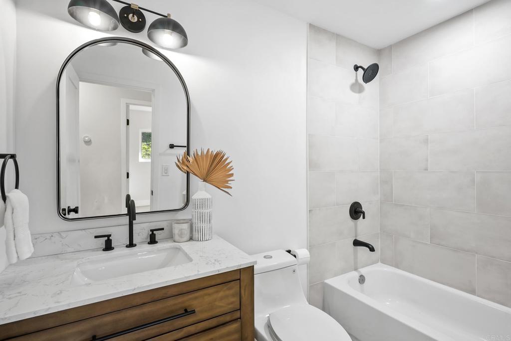 5898 Agee Street San Diego, CA 92122 - Photo 35 of 40 a bathroom with a sink and a mirror