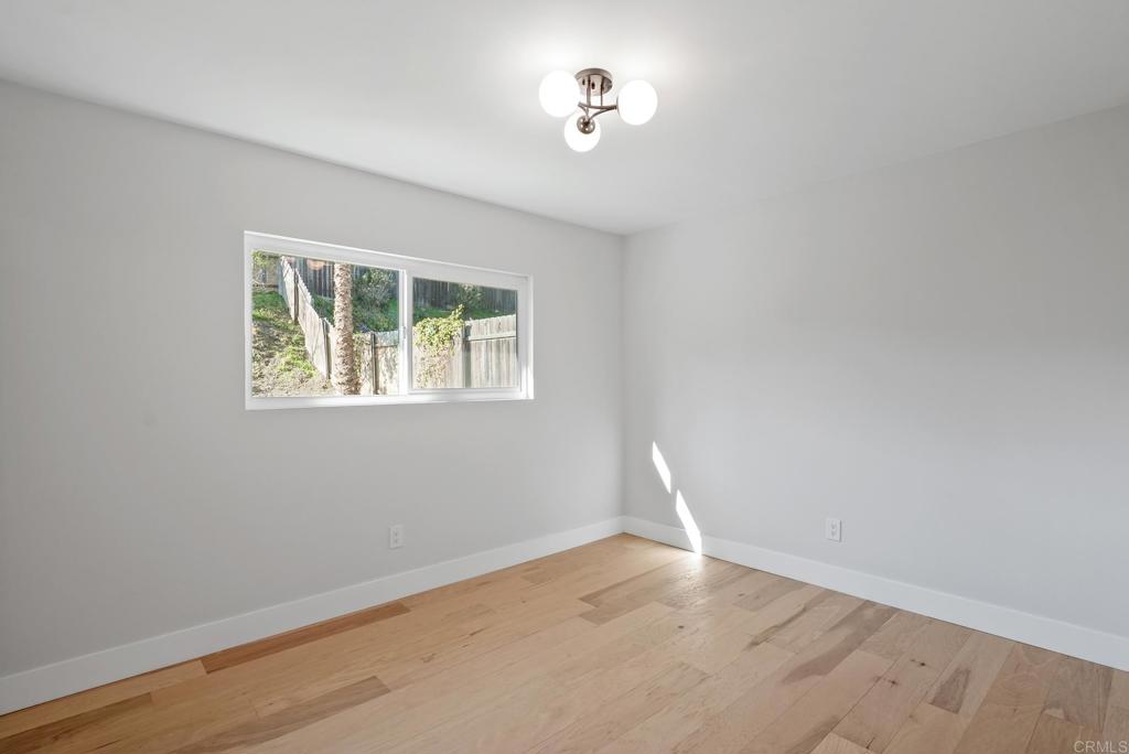 5898 Agee Street San Diego, CA 92122 - Photo 36 of 40 wooden floor in an empty room with a window