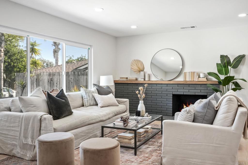 5898 Agee Street San Diego, CA 92122 - Photo 7 of 40 a living room with furniture a fireplace and a large window