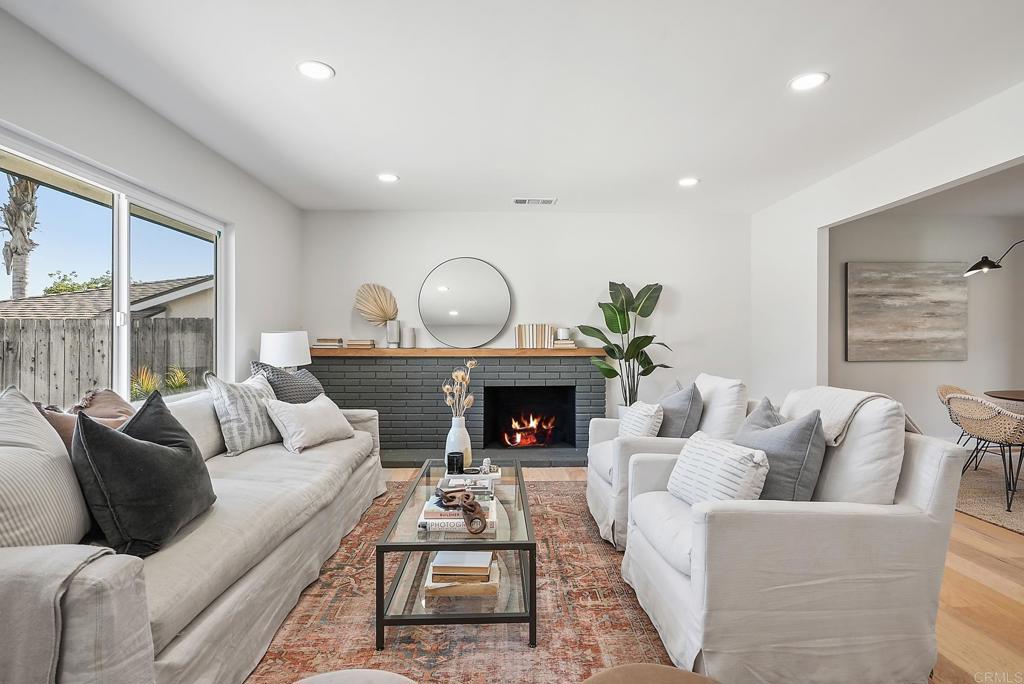 5898 Agee Street San Diego, CA 92122 - Photo 8 of 40 a living room with furniture a fireplace and a large window