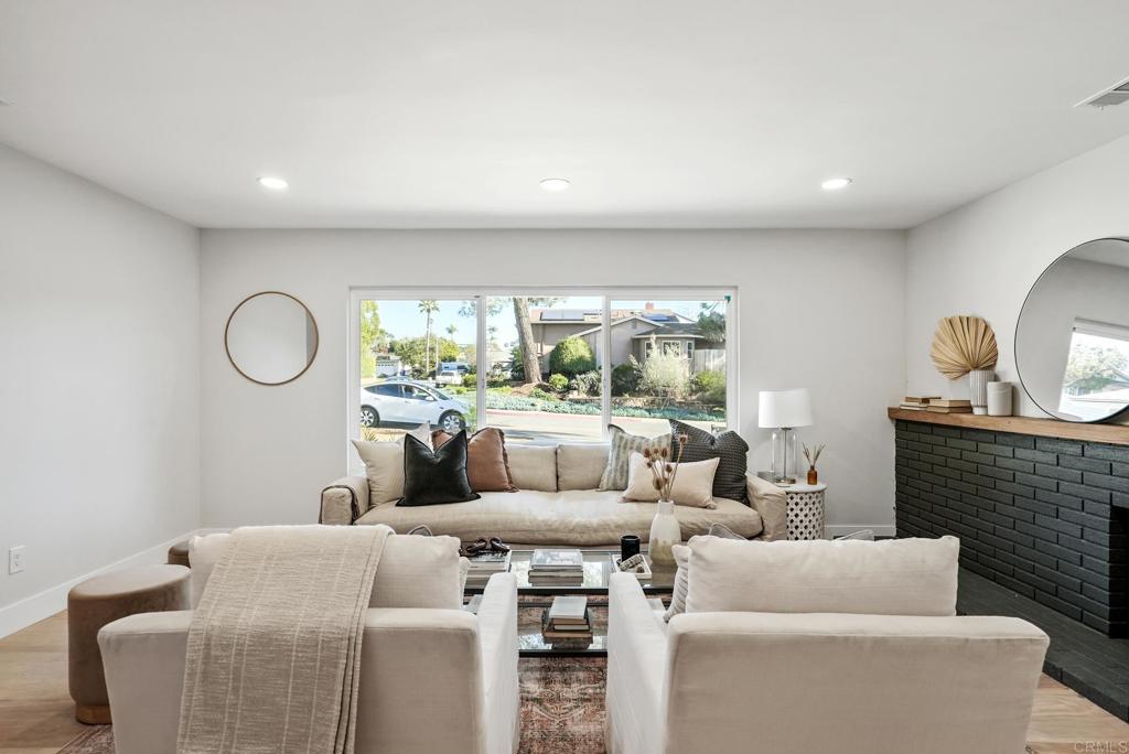 5898 Agee Street San Diego, CA 92122 - Photo 10 of 40 a living room with furniture a large window and a fireplace